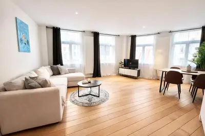 a living room with a couch and a table at Luma Residence in Brussels