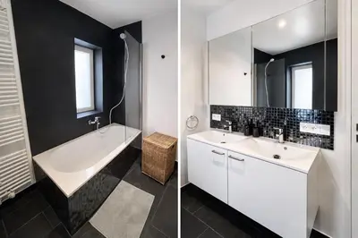 a bathroom with a white tub and a sink and a mirror at Luma Residence in Brussels