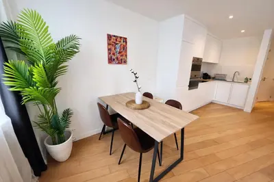 a dining room with a table and a potted plant at Luma Residence in Brussels