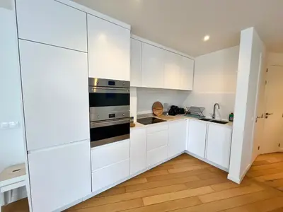 a kitchen with white cabinets and a stove at Luma Residence in Brussels