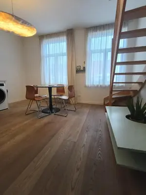 a living room with a table and two chairs at Duplex apartment in the center, best comfort in Brussels