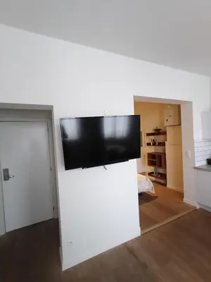 a flat screen tv on top of a white wall at Duplex apartment in the center, best comfort in Brussels