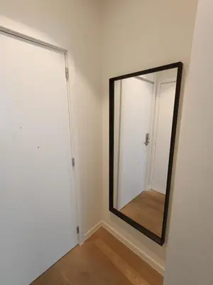 a mirror in the corner of a room with a door at Duplex apartment in the center, best comfort in Brussels