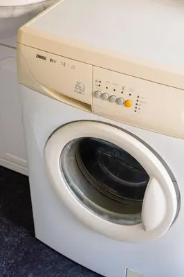 a white washing machine with its door open at Prime Location Apartment Chtelain Saint-Gilles Self checkin in Brussels