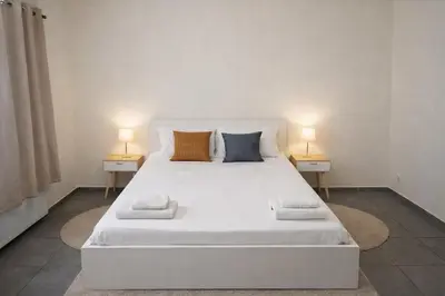 a white bed with two lamps on two tables at Central Brussels Spacious 2BR near Grand Place 1 in Brussels