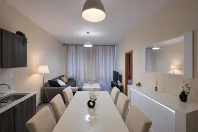 a kitchen and living room with a table and a couch at Central Brussels Spacious 2BR near Grand Place 1 in Brussels