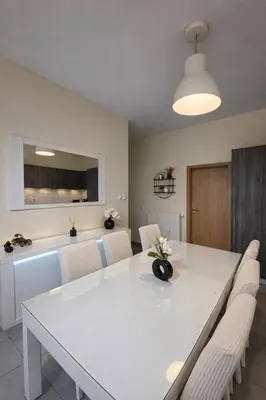 a dining room with a white table and chairs at Central Brussels Spacious 2BR near Grand Place 1 in Brussels