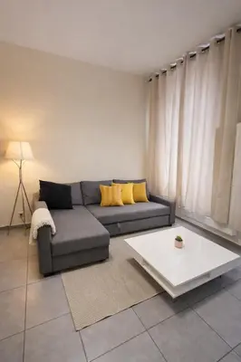 a living room with a couch and a table at Central Brussels Spacious 2BR near Grand Place 1 in Brussels