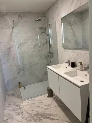 a white bathroom with a sink and a shower at Apartment in Lochristi, close to Ghent & Lokeren! in Lochristi