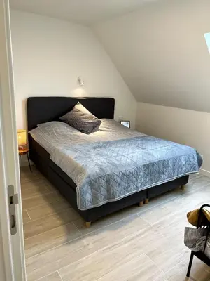 a bedroom with a large bed in a room at Apartment in Lochristi, close to Ghent & Lokeren! in Lochristi