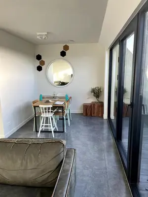 a dining room with a table and a mirror at Apartment in Lochristi, close to Ghent & Lokeren! in Lochristi