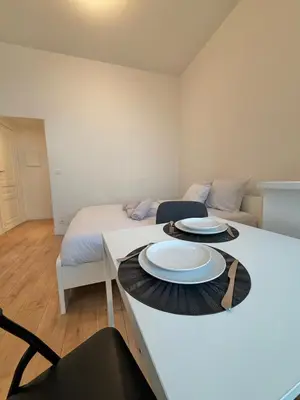 a room with a bed and a table with plates on it at Le sily appartement Bruxelles centre-ville in Brussels