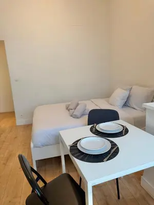 a living room with a table and a couch at Le sily appartement Bruxelles centre-ville in Brussels