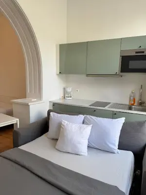 a couch with two white pillows in a kitchen at Le sily appartement Bruxelles centre-ville in Brussels