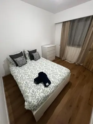 a bedroom with a bed with a shirt on it at Un cocon chaleureux in Brussels