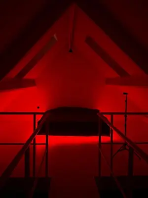 a red room with a bed with a red light at Amazing apartment with view in the centre in Antwerp