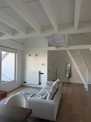 a living room with a couch and a large window at Amazing apartment with view in the centre in Antwerp