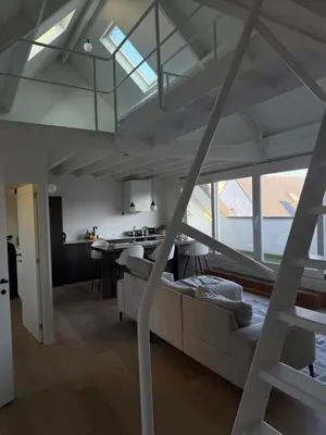 a living room with a couch and a table at Amazing apartment with view in the centre in Antwerp