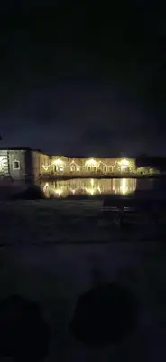 a bench in front of a building at night at Erflogies Fort Liezele