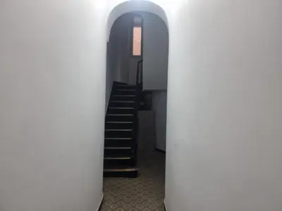 a hallway with white columns and a staircase at Zoe's world in Brussels