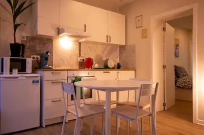 a kitchen with a table and chairs in a kitchen at Zoe's world in Brussels