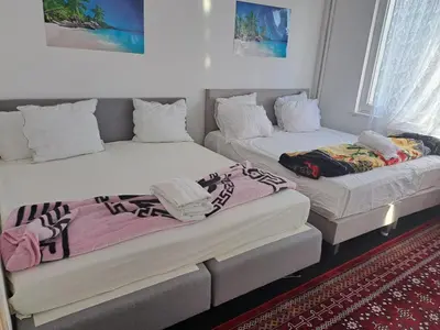 a room with two beds and a couch at Hébergement touristique à Bruxelles capitale 2026 in Brussels