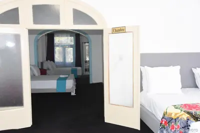 a bedroom with two beds and a mirror at Hébergement touristique à Bruxelles capitale 2026 in Brussels