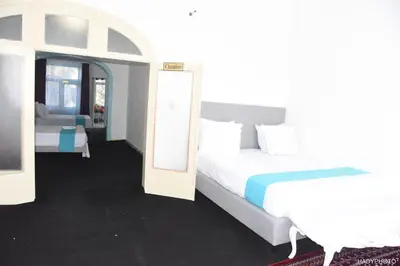 a bedroom with a white bed and a mirror at Hébergement touristique à Bruxelles capitale 2026 in Brussels