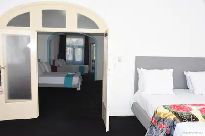 a bedroom with two beds and an arched doorway at Hébergement touristique à Bruxelles capitale 2026 in Brussels