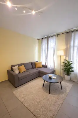 a living room with a couch and a table at Central Brussels Spacious 2BR near Grand Place3 in Brussels