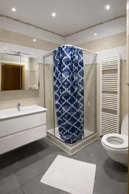 a bathroom with a shower and a toilet and a sink at Central Brussels Spacious 2BR near Grand Place3 in Brussels
