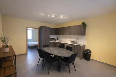 a kitchen with a table and chairs in a room at Central Brussels Spacious 2BR near Grand Place3 in Brussels