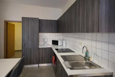 a kitchen with a sink and a microwave at Central Brussels Spacious 2BR near Grand Place3 in Brussels
