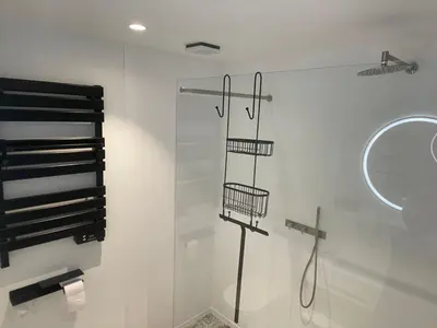 a bathroom with a shower with a glass door at Aplusstudio in Zottegem
