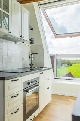a kitchen with a sink and a large window at Bed & Port luxury villa in Kallo