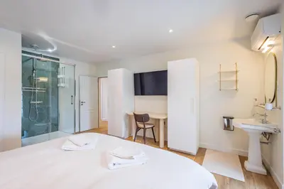 a bedroom with a bed and a sink and a shower at Bed & Port luxury villa in Kallo