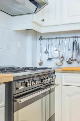 a kitchen with a stove and utensils on the wall at Bed & Port luxury villa in Kallo