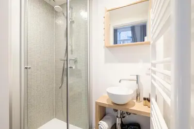 a bathroom with a sink and a shower at Cosy 1 bedroom apartment close to Grand Place in Brussels