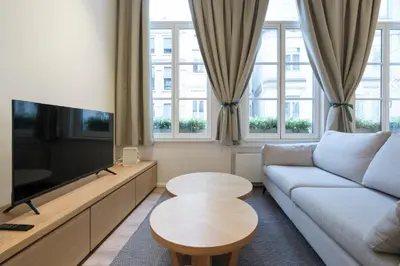 a living room with a couch and a tv at Cosy 1 bedroom apartment close to Grand Place in Brussels