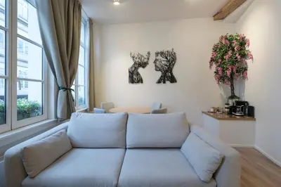 a living room with a couch and a window at Cosy 1 bedroom apartment close to Grand Place in Brussels