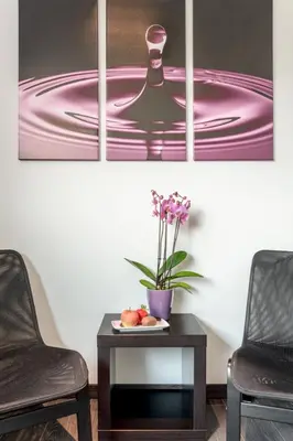 two chairs and a table with a pink painting at B&B Molmento in Mol