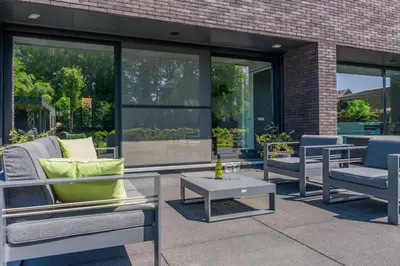 a patio with two chairs and a table at B&B Molmento in Mol