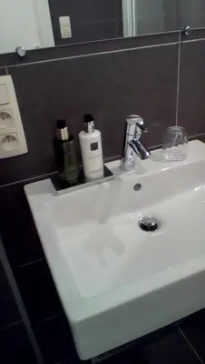 a white sink in a bathroom with a mirror at RectoVersoVV in Sint-Pieters-Leeuw