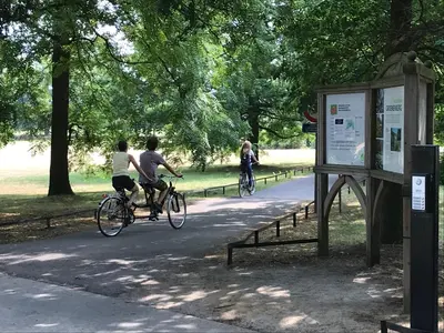 two people riding bikes down a path in a park at RectoVersoVV in Sint-Pieters-Leeuw