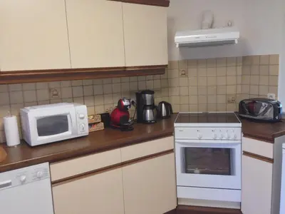a kitchen with a white microwave and a stove at RectoVersoVV in Sint-Pieters-Leeuw