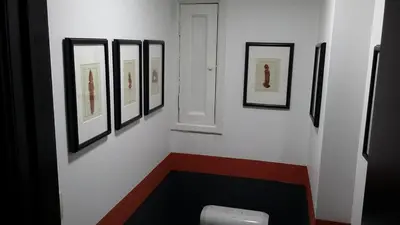 a room with a white wall with pictures on it at Signature Designers Appartment in Brussels