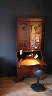 a wooden desk with a chair and a cabinet at Signature Designers Appartment in Brussels