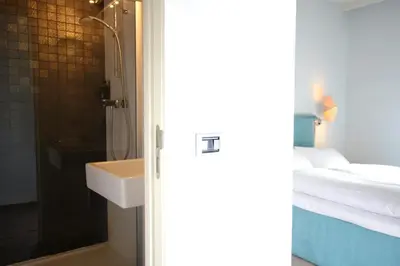 a bathroom with a sink and a shower at Trip Inn Eden Antwerpen in Antwerp