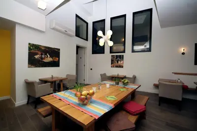 a dining room with a wooden table with fruit on it at Trip Inn Eden Antwerpen in Antwerp