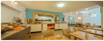 a kitchen and dining room with tables and chairs at Trip Inn Eden Antwerpen in Antwerp